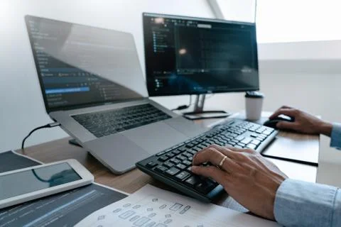 Programmer Typing Code on desktop computer, Developing programming and coding 库存照片