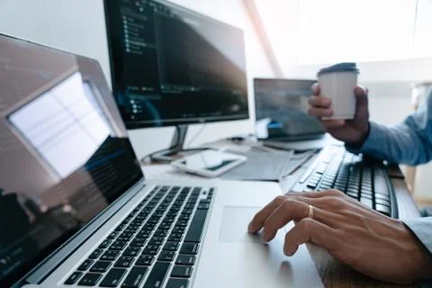 Programmer Typing Code on desktop computer, Developing programming and coding Stock Photos
