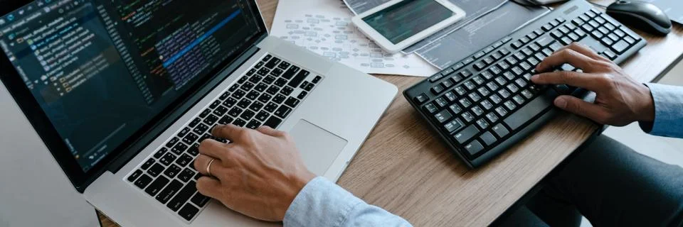 Programmer Typing Code on desktop computer, Developing programming and coding 写真素材