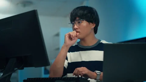 Programmer typing code with focus on software development Video stock 313807594