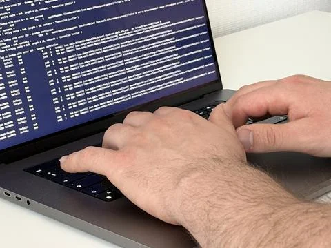Programmer typing code on laptop, Close up angle Stock Photos