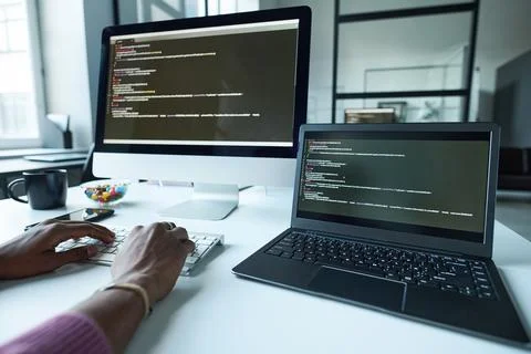 Programmer typing computer codes on computer Stock Photos