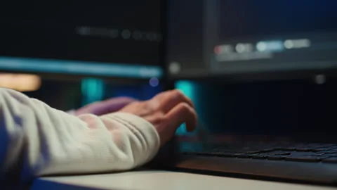 Programmer typing on computer to fix software vulnerabilities, close up Stock Footage 283689714