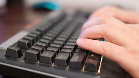 A programmer typing on a computer keyboard to send emails. Video macro shooting Stock Footage 225161649