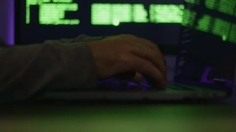 Programmer typing with hands on keyboard and computer code displayed on Stock Footage 317940567