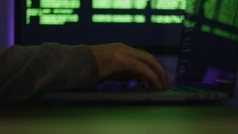 Programmer typing with hands on keyboard and computer code displayed on pro.. 스톡 사진