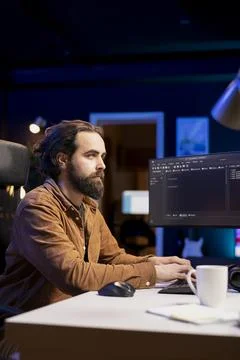 Programmer typing on keyboard, installing fortified code on PC Stock Photos