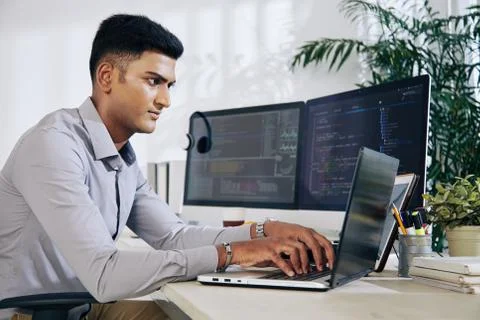 Programmer typing on laptop Foto stock