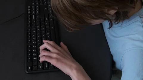 Programmer typing rapidly on a black keyboard, creating code Stock Footage 283913822