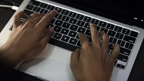 Programmer Typing Source Code on Laptop Computer in Modern Workspace Vídeo Stock 340450376