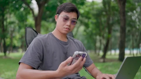 Programmer use laptop discuss project details with colleague by phone Video stock 283186719