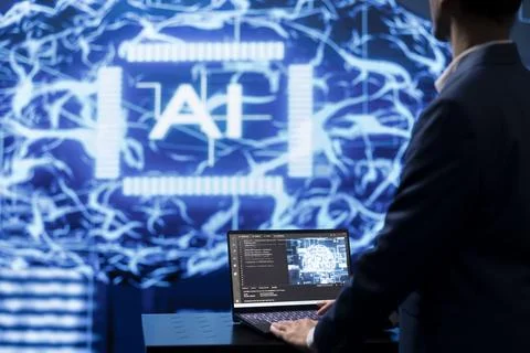 Programmer using AI cognitive computing on laptop 写真素材