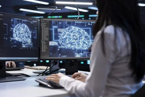 Programmer using AI tech on computer to do maintenance in server room Foto stock