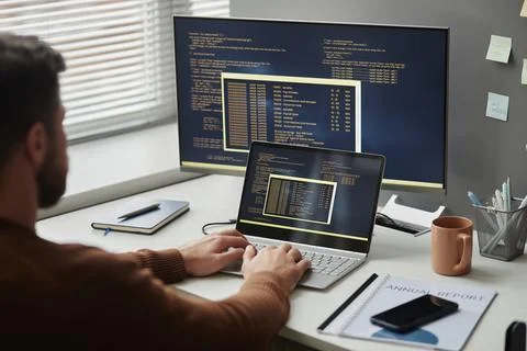 Programmer Using Computer in Office and Writing Code Stock Photos