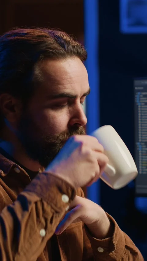Programmer using computer to update AI neural networks, drinking coffee Stock Footage 264511568