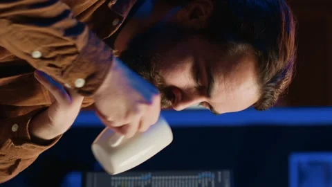 Programmer using computer to update AI neural networks, drinking coffee Stock Footage 265108106