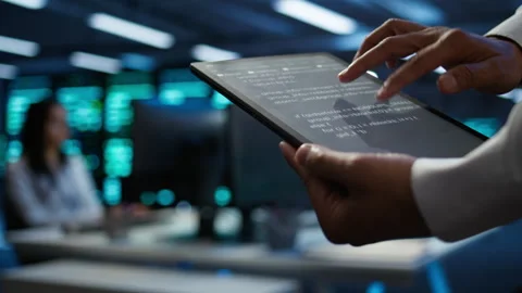Programmer using device in data center, close up Stock Footage 280802304