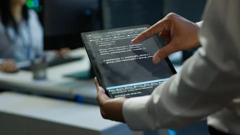 Programmer using device in data center, close up Stock Photos