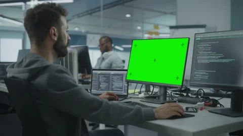 Programmer using Green Screen Comuter in Office Stock Footage 159542859