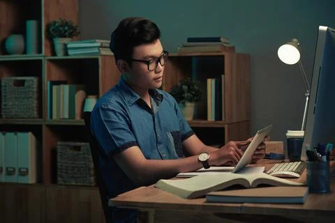 Programmer Using Tablet In Dark Home Office 写真素材