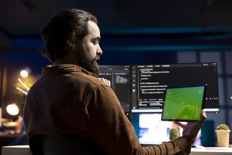 Programmer using tablet to fix vulnerabilities compromising systems 스톡 사진