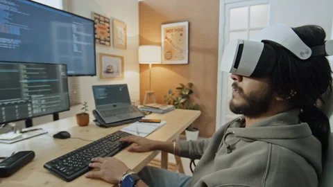 Programmer in VR Goggles Working on Computer Code from Home Stock Footage 255929186