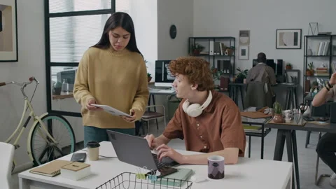 Programmer Walking to Colleagues Desk and Showing Him Tech Issues on Tablet Stock Footage 299234660