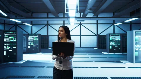 Programmer walking in data center, coding on laptop Stock Footage 280715735