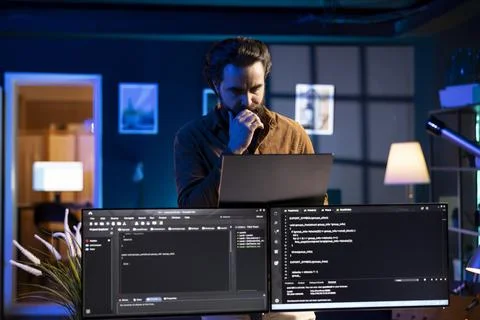 Programmer walking through apartment thinking how to solve coding problems Stock Photos