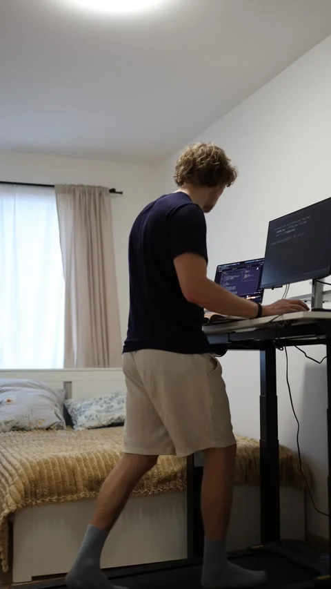 Programmer walking on treadmill while developing software Stock-Footage 346881382