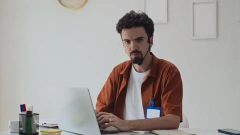 Programmer Wearing Headset and Working on Wireless Laptop Stock-Footage 253499879