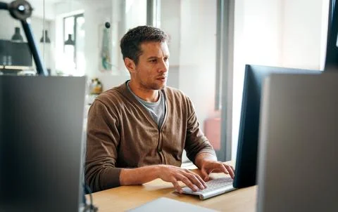 Programmer, web developer, designer working at office comparing mobile and 写真素材
