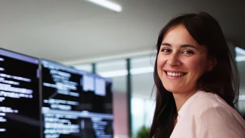 Programmer Woman Coding On Multiple Computers Stock Footage 284485429