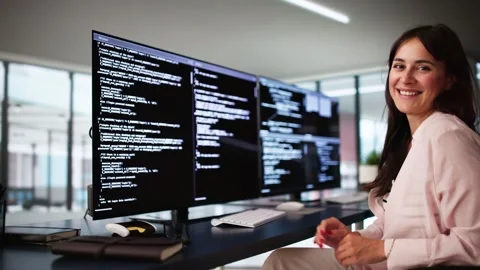 Programmer Woman Coding On Multiple Computers Stock Footage 285880420