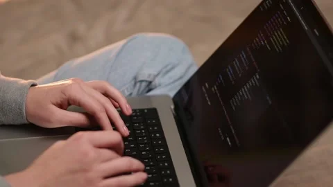 Programmer woman writes program HTML code while sitting on sofa Stock Footage 219851049
