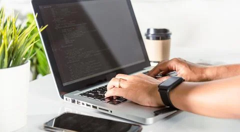 Programmer woman writing program HTML code sitting at workplace in office Foto stock