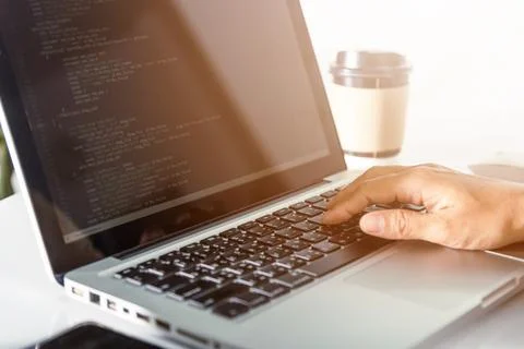 Programmer woman writing program HTML code sitting at workplace in office Stock Photos