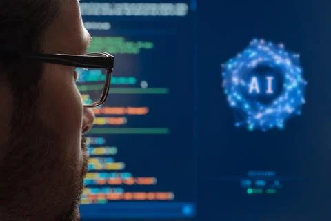 Programmer Working with AI Assistant on Computer Monitor. Stock Photos