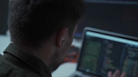 The programmer is working at a computer and is negotiating wirelessly with a Stock Footage 169531043