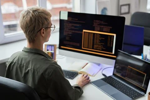 Programmer working on computer with codes Stock Photos