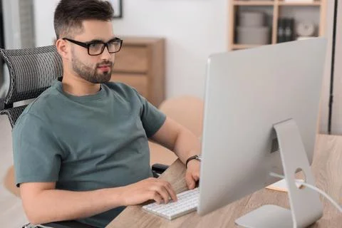 Programmer working with computer at desk in office 写真素材