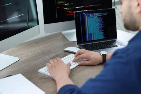 Programmer working with computer at desk in office, closeup Stock Photos