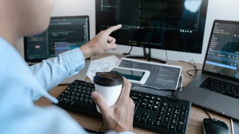 Programmer working On Computer In IT Office Typing Data Coding in software an Stock Photos
