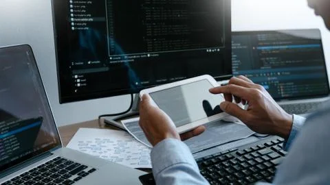 Programmer working On Computer In IT Office Typing Data Coding in software an Stock Photos