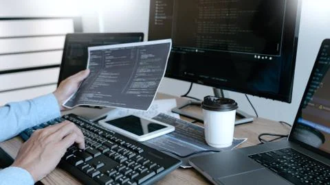 Programmer working On Computer In IT Office Typing Data Coding in software an Stock Photos