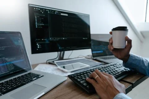 Programmer working On Computer In IT Office Typing Data Coding in software an Foto stock