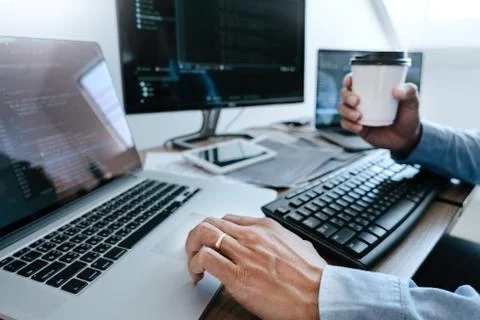 Programmer working On Computer In IT Office Typing Data Coding in software an 写真素材