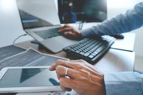 Programmer working On Computer In IT Office Typing Data Coding in software an Stock Photos