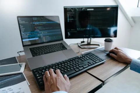 Programmer working On Computer In IT Office Typing Data Coding in software an Stock Photos