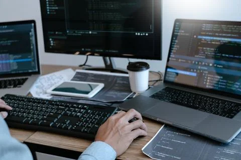 Programmer working On Computer In IT Office Typing Data Coding in software an Foto stock